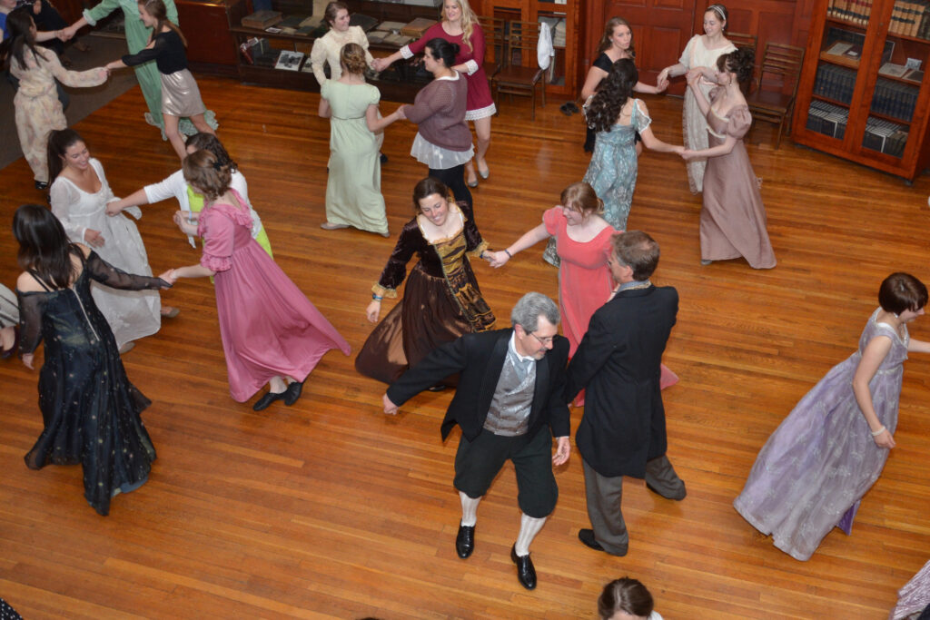 An image of people in period dress English Country Dancing.